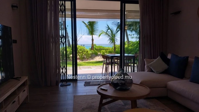 Elegant beachfront 3-bedroom apartment with private garden & direct beach access. 