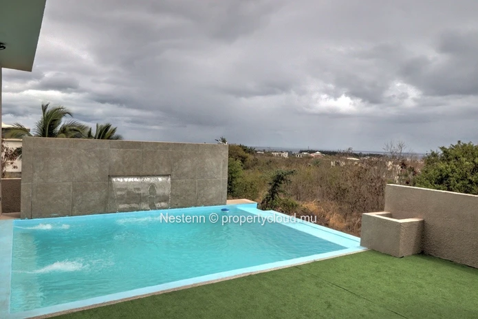 Modern house with swimming pool upstairs and sea and mountain views.