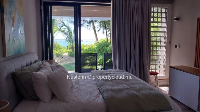 Elegant beachfront 3-bedroom apartment with private garden & direct beach access. 