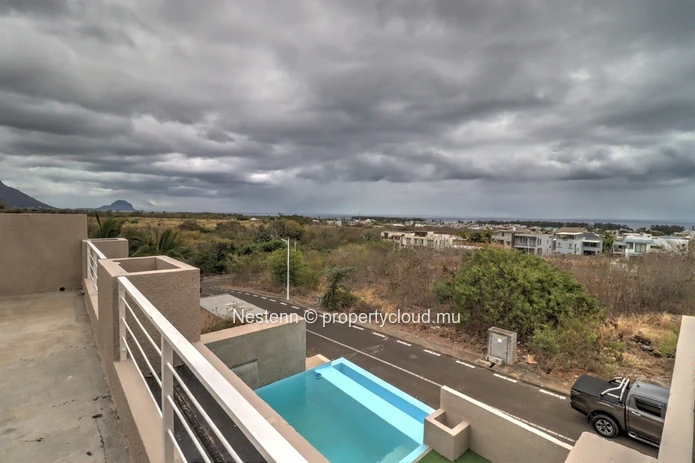 Modern house with swimming pool upstairs and sea and mountain views.