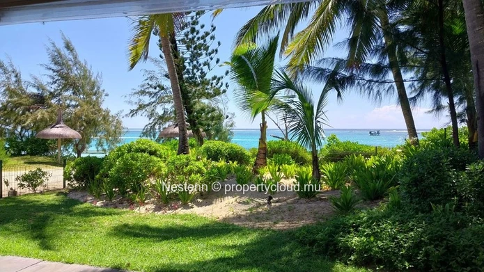 Elegant beachfront 3-bedroom apartment with private garden & direct beach access. 