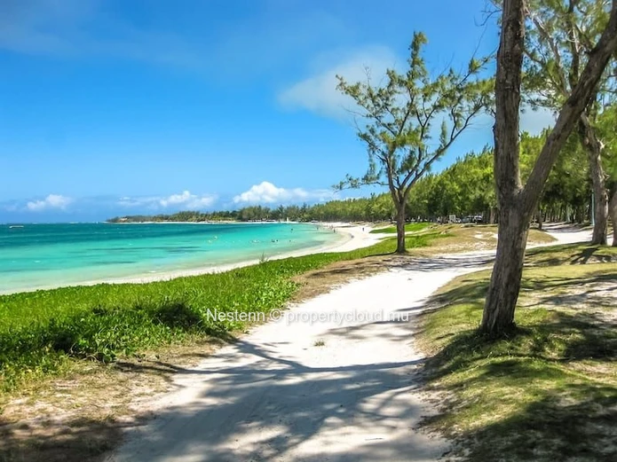 Elegant beachfront 3-bedroom apartment with private garden & direct beach access. 