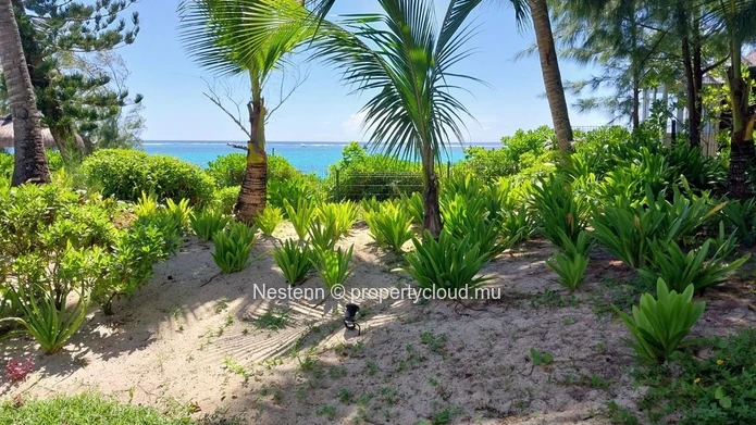 Elegant beachfront 3-bedroom apartment with private garden & direct beach access. 